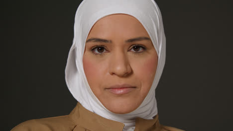 Close-Up-Studio-Head-And-Shoulders-Portrait-Of-Muslim-Woman-Wearing-Hijab